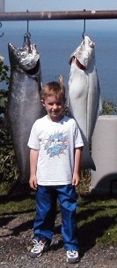 AJ didn't get to go fishing with dad and brother but he is so CUTE standing there with a halibut and king salmon.